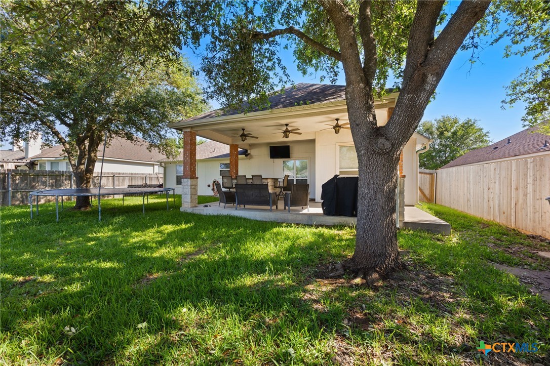 910 Neuberry Cliffe Temple, TX 76502 - Photo 27 of 32 a backyard of a house with table and chairs