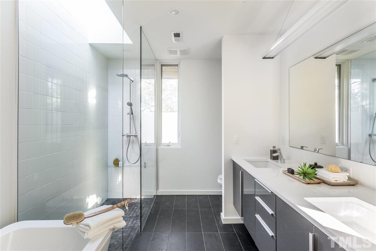 562 New Bern Avenue Raleigh, NC 27601 - Photo 22 of 29 a bathroom with a granite countertop sink a toilet and shower