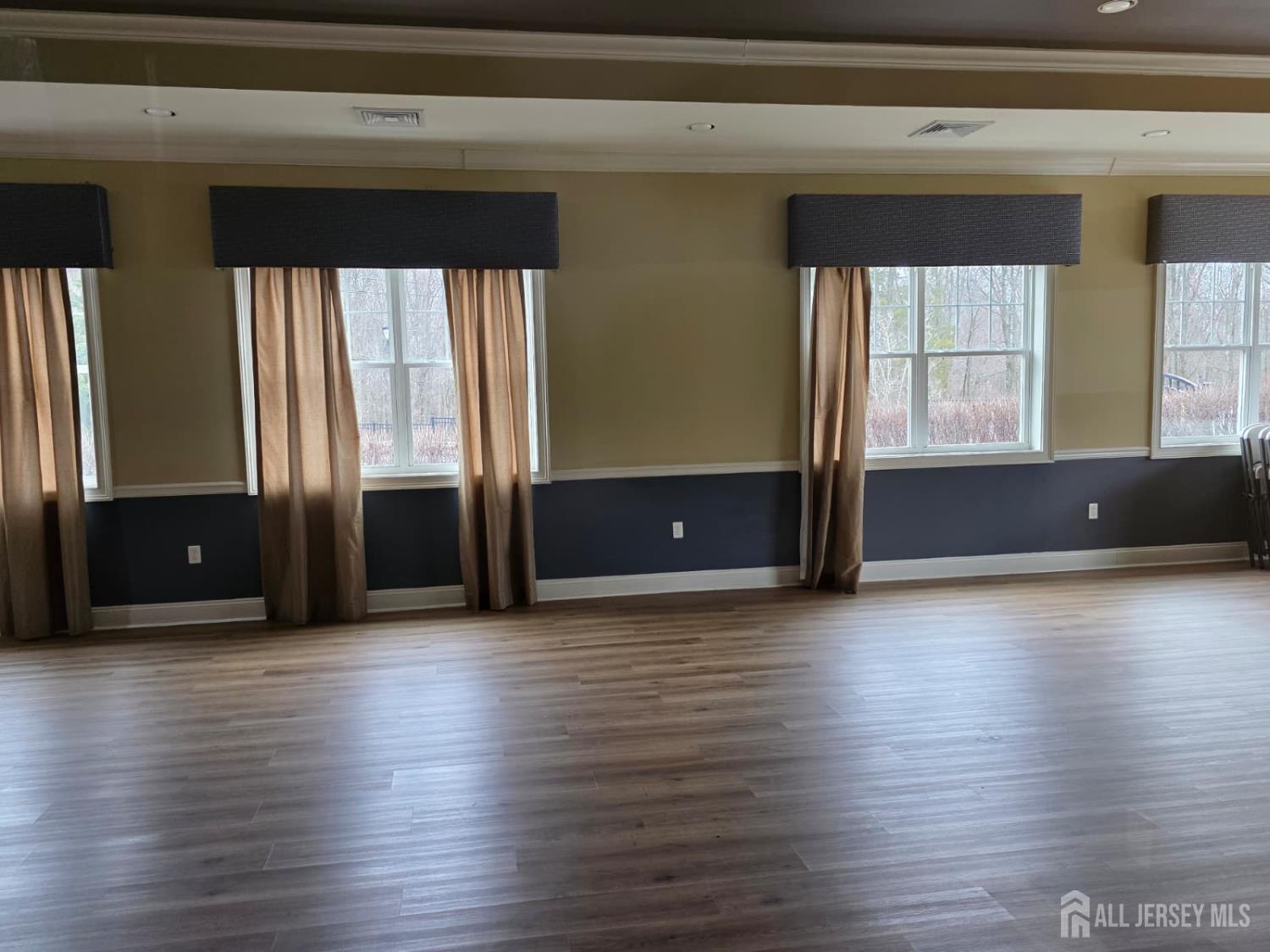 631 Strassle Way South Plainfield, NJ 07080 - Photo 11 of 34 an empty room with wooden floor and windows