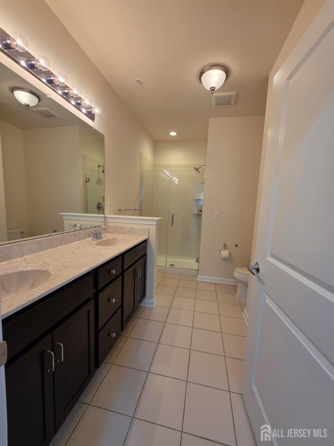 631 Strassle Way South Plainfield, NJ 07080 - Photo 16 of 34 a spacious bathroom with a double vanity sink a mirror and a shower