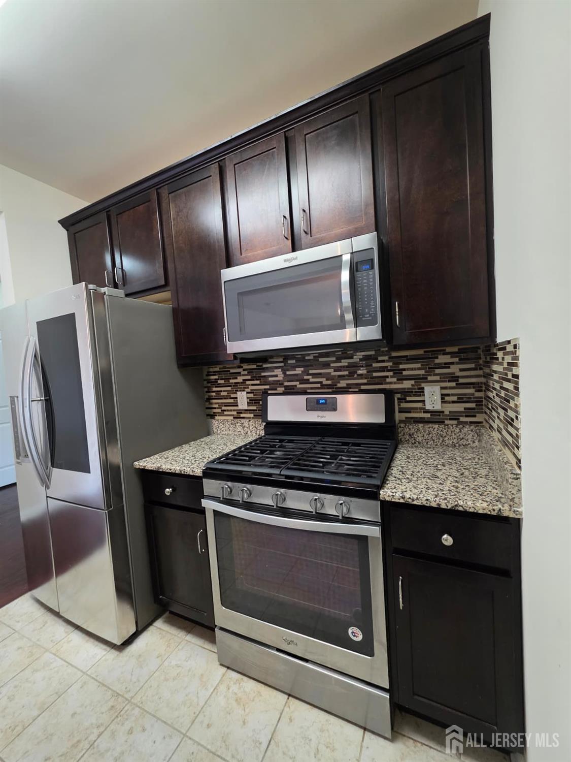 631 Strassle Way South Plainfield, NJ 07080 - Photo 3 of 34 a kitchen with granite countertop stainless steel appliances and wooden cabinets