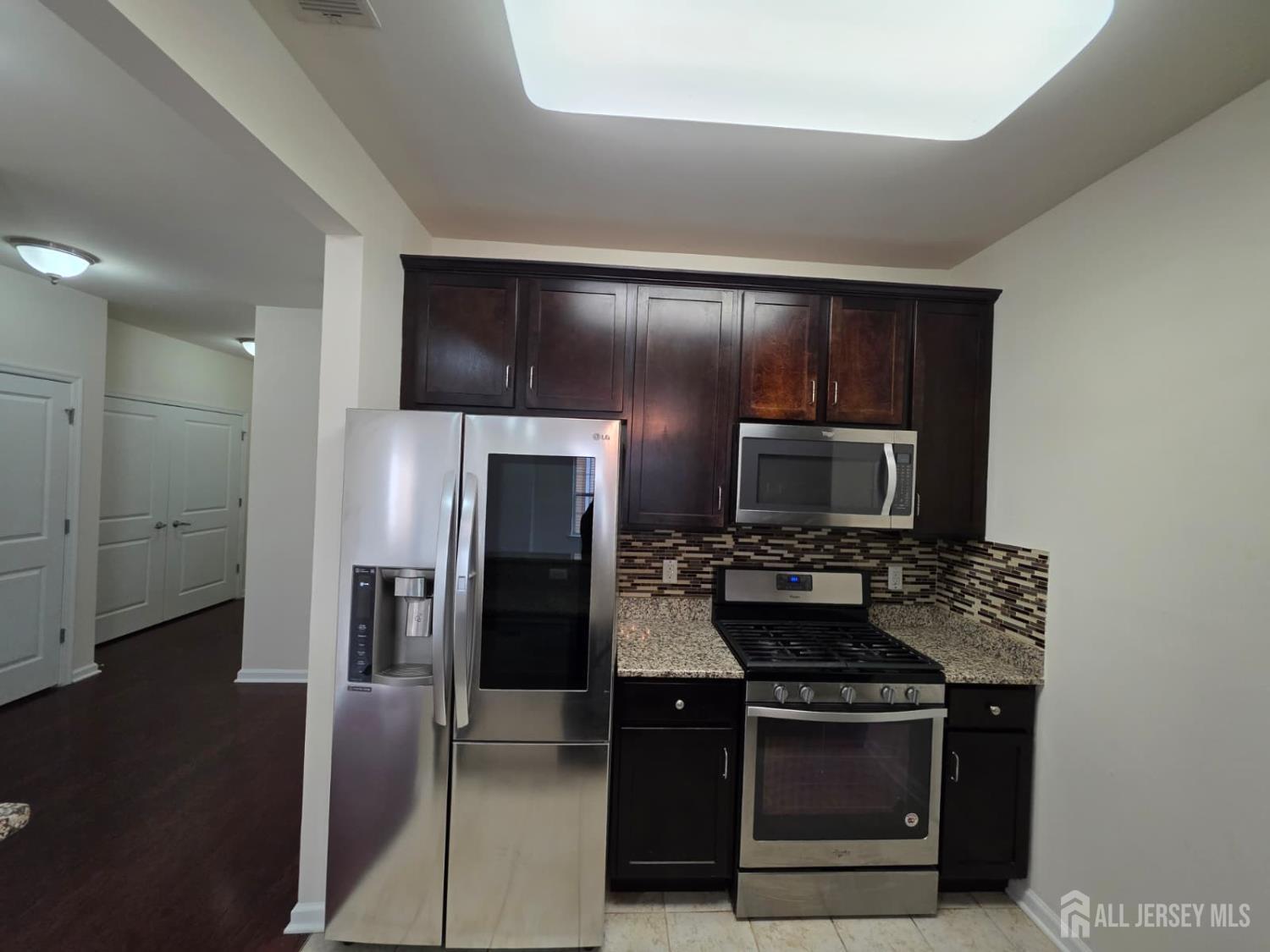631 Strassle Way South Plainfield, NJ 07080 - Photo 4 of 34 a kitchen with a refrigerator stove and microwave