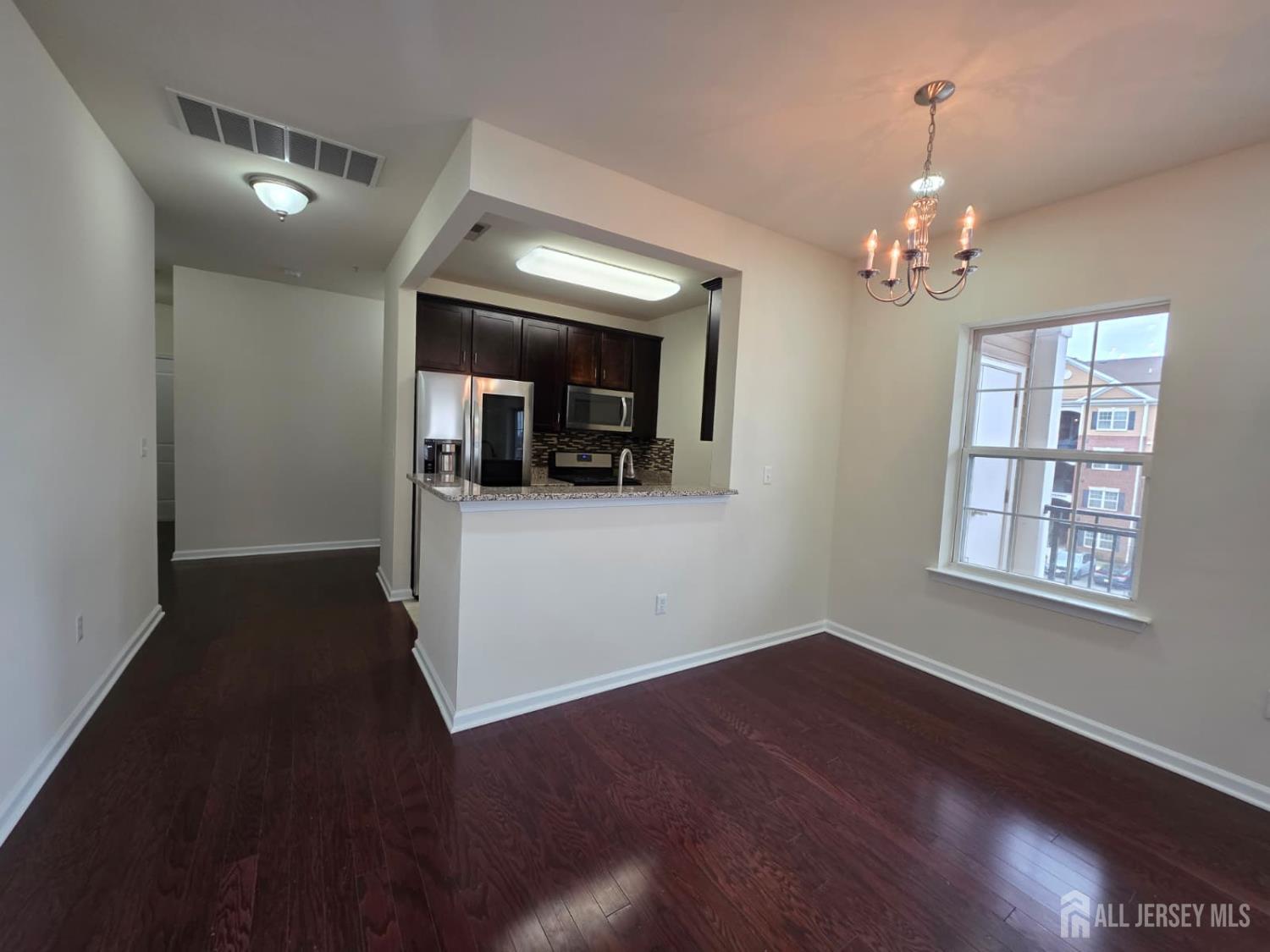 631 Strassle Way South Plainfield, NJ 07080 - Photo 6 of 34 wooden floor in an empty room with a window