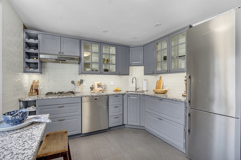 64 Jericho Road, Unit 64 Weston, MA 02493 - Photo 11 of 26 a kitchen with stainless steel appliances granite countertop a refrigerator sink and cabinets