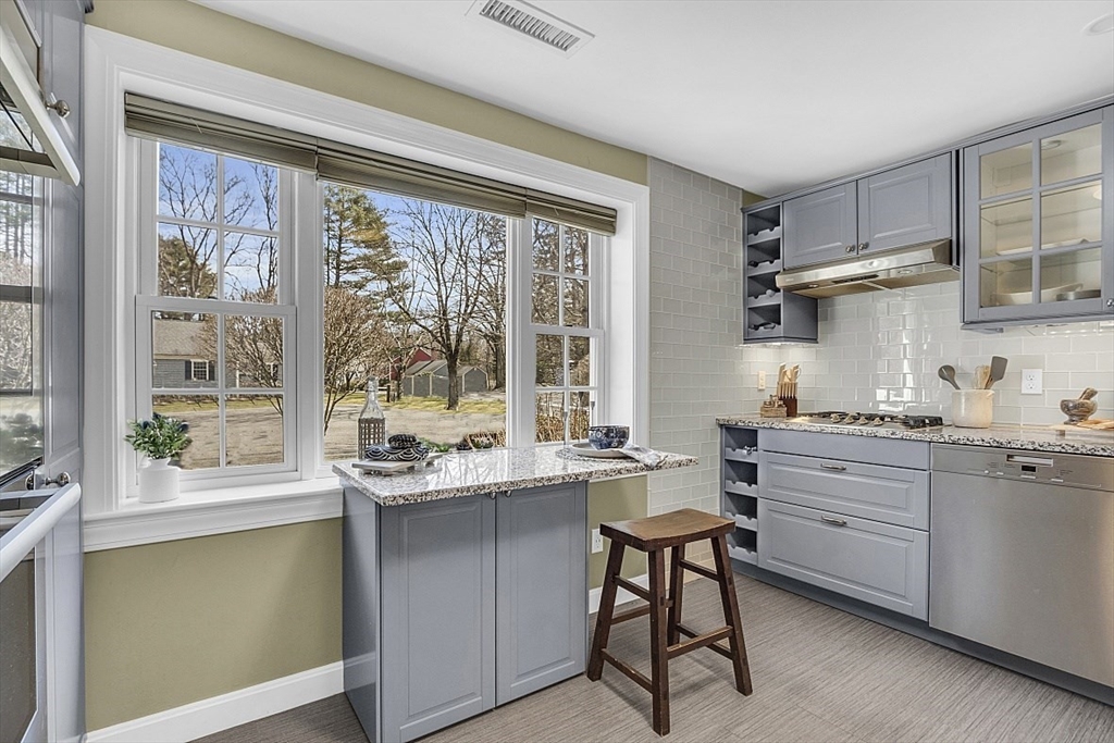 64 Jericho Road, Unit 64 Weston, MA 02493 - Photo 12 of 26 a kitchen with granite countertop white cabinets and white appliances