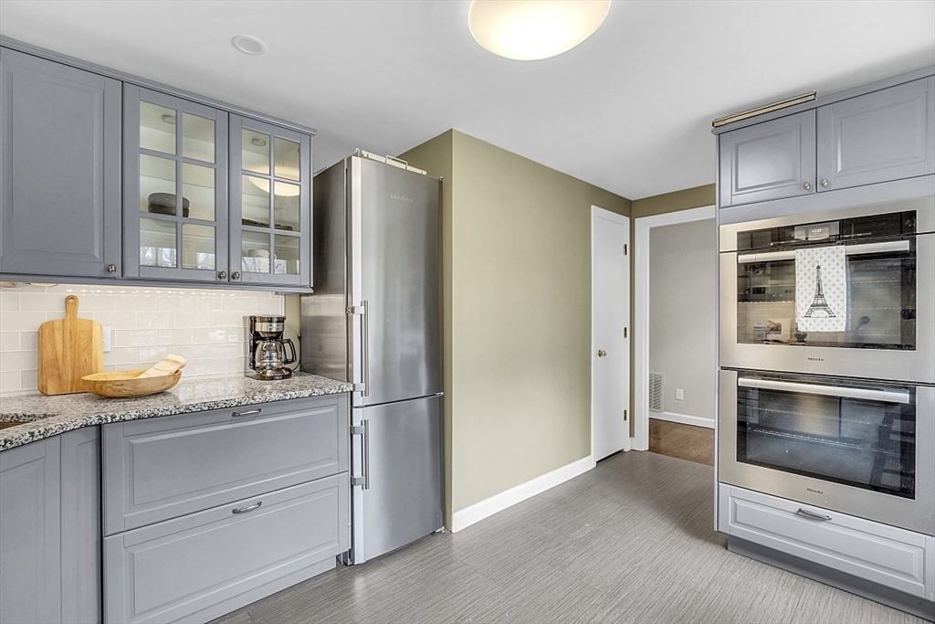64 Jericho Road, Unit 64 Weston, MA 02493 - Photo 15 of 26 a kitchen with granite countertop cabinets stainless steel appliances and a counter space