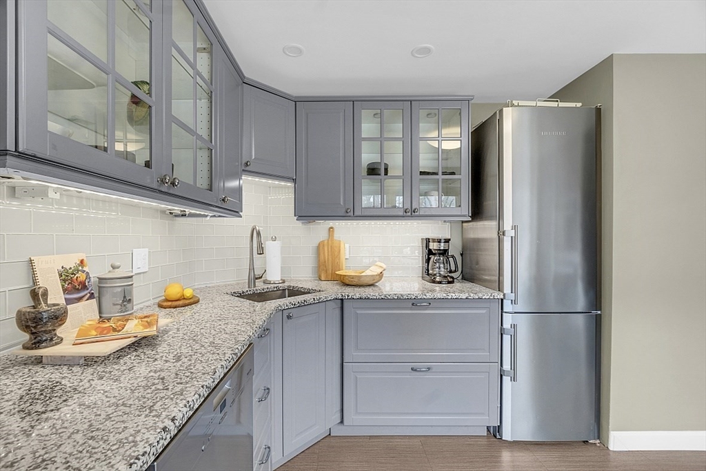 64 Jericho Road, Unit 64 Weston, MA 02493 - Photo 16 of 26 a kitchen with stainless steel appliances granite countertop a refrigerator and a sink