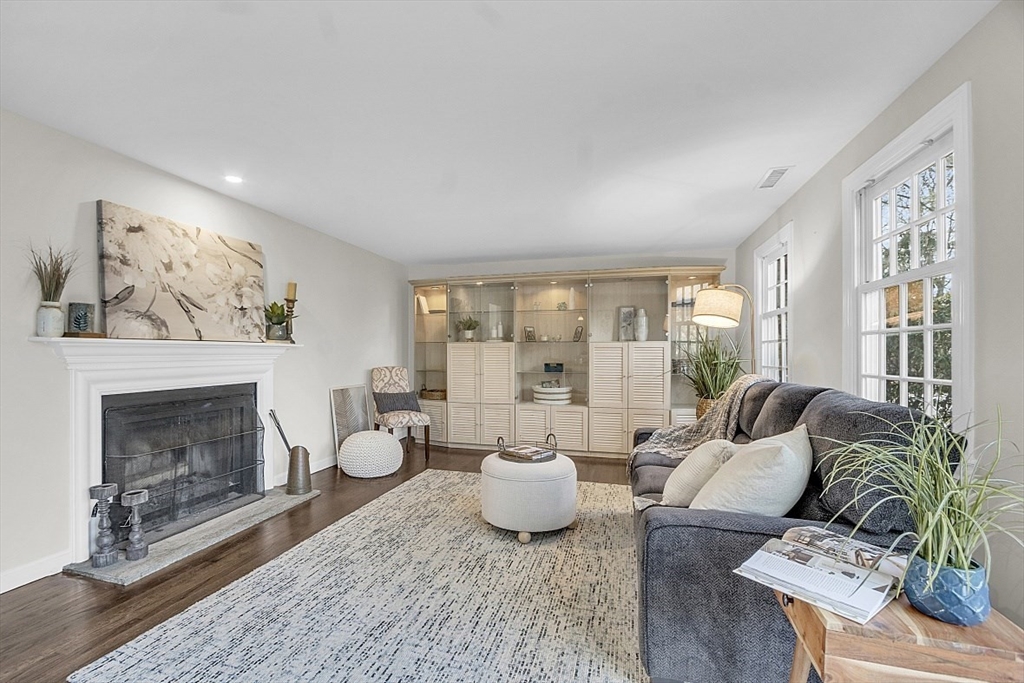 64 Jericho Road, Unit 64 Weston, MA 02493 - Photo 18 of 26 a living room with furniture a window and a fireplace