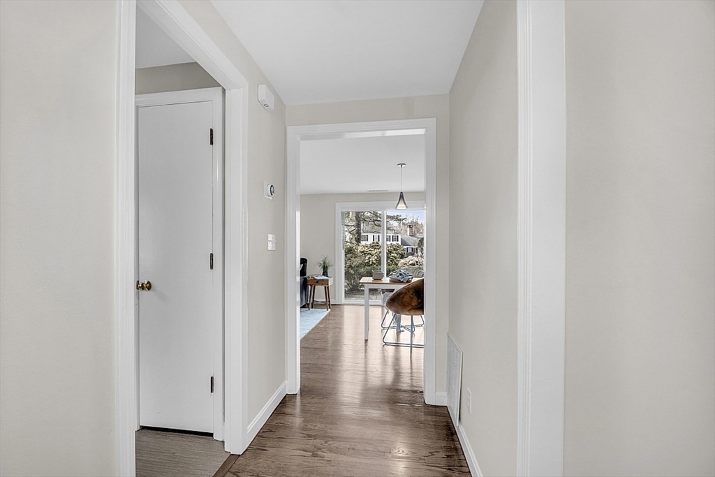 64 Jericho Road, Unit 64 Weston, MA 02493 - Photo 24 of 26 a view of a hallway with wooden floor and a bathroom