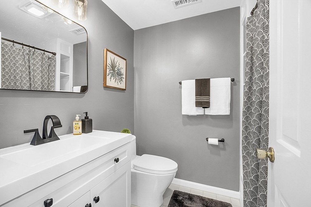 64 Jericho Road, Unit 64 Weston, MA 02493 - Photo 4 of 26 a bathroom with a toilet a sink and mirror