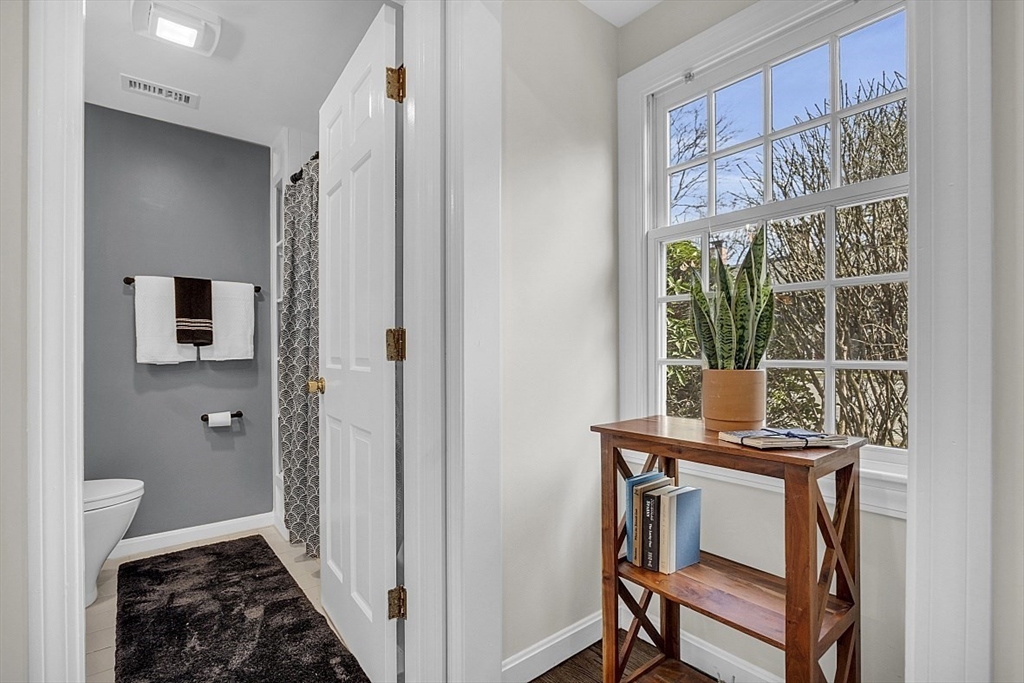 64 Jericho Road, Unit 64 Weston, MA 02493 - Photo 8 of 26 a view of a hallway with furniture and front door