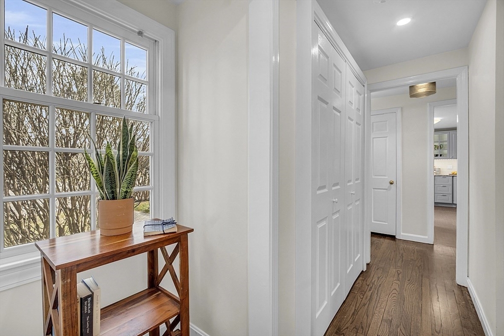 64 Jericho Road, Unit 64 Weston, MA 02493 - Photo 9 of 26 a view of a hallway with wooden floor and furniture