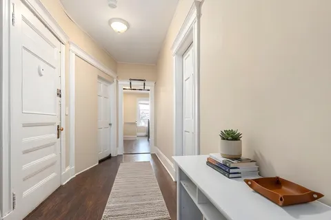 a view of a bedroom with wooden floor and bathroom
