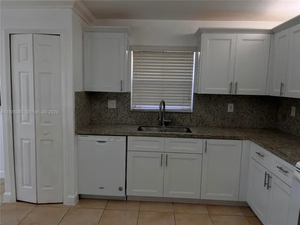 a kitchen with white cabinets