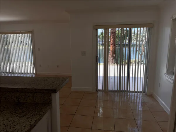 a view of a livingroom with an empty space and a window