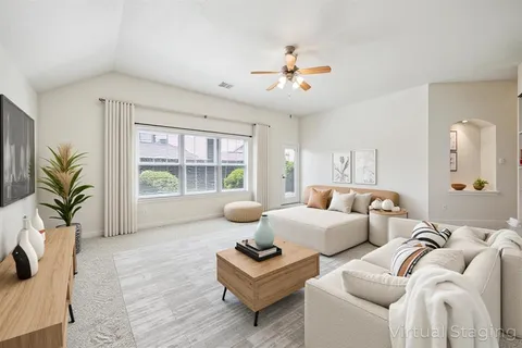 a living room with furniture and a large window