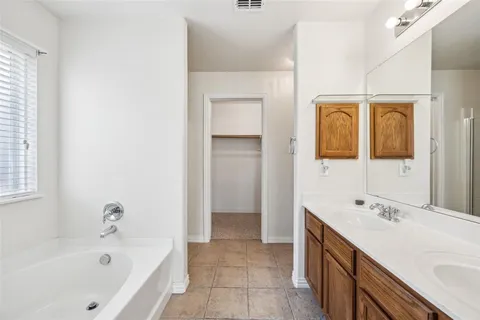 a bathroom with a bathtub and a sink