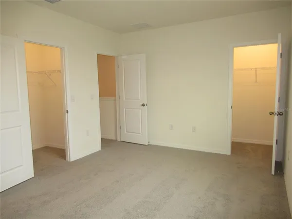 an empty room with closet area