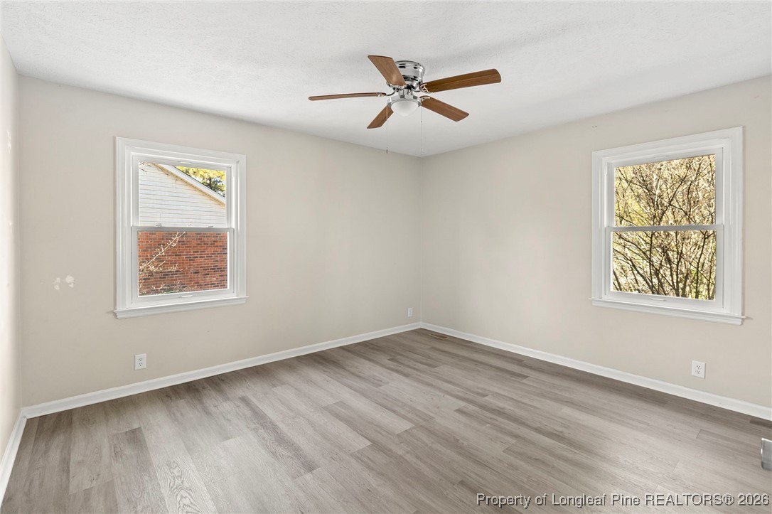 5196 Remington Road Fayetteville, NC 28311 - Photo 17 of 34 a view of an empty room with a window and wooden floor