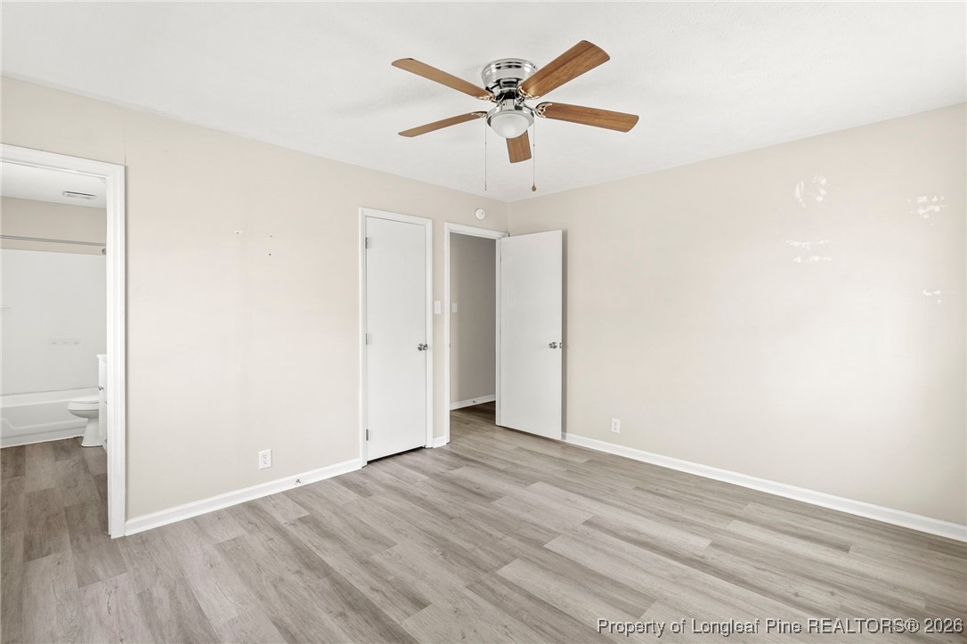 5196 Remington Road Fayetteville, NC 28311 - Photo 18 of 34 an empty room with wooden floor and ceiling fan