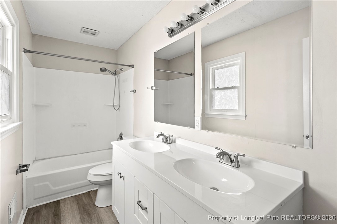 5196 Remington Road Fayetteville, NC 28311 - Photo 19 of 34 a bathroom with a sink toilet and shower