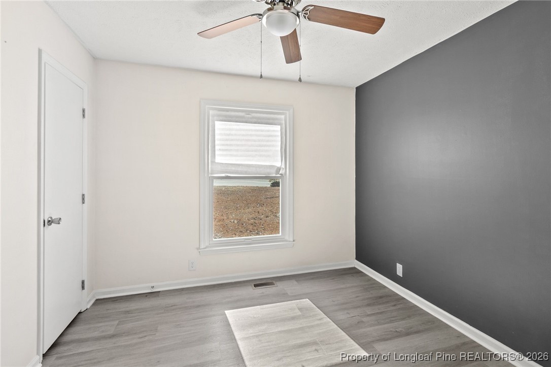 5196 Remington Road Fayetteville, NC 28311 - Photo 22 of 34 an empty room with windows and fan
