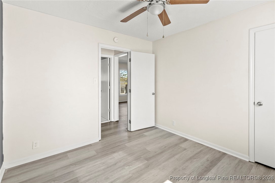 5196 Remington Road Fayetteville, NC 28311 - Photo 23 of 34 an empty room with wooden floor and ceiling fan