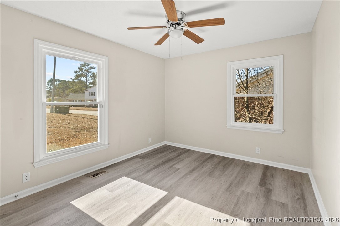 5196 Remington Road Fayetteville, NC 28311 - Photo 26 of 34 a view of an empty room with window and wooden floor