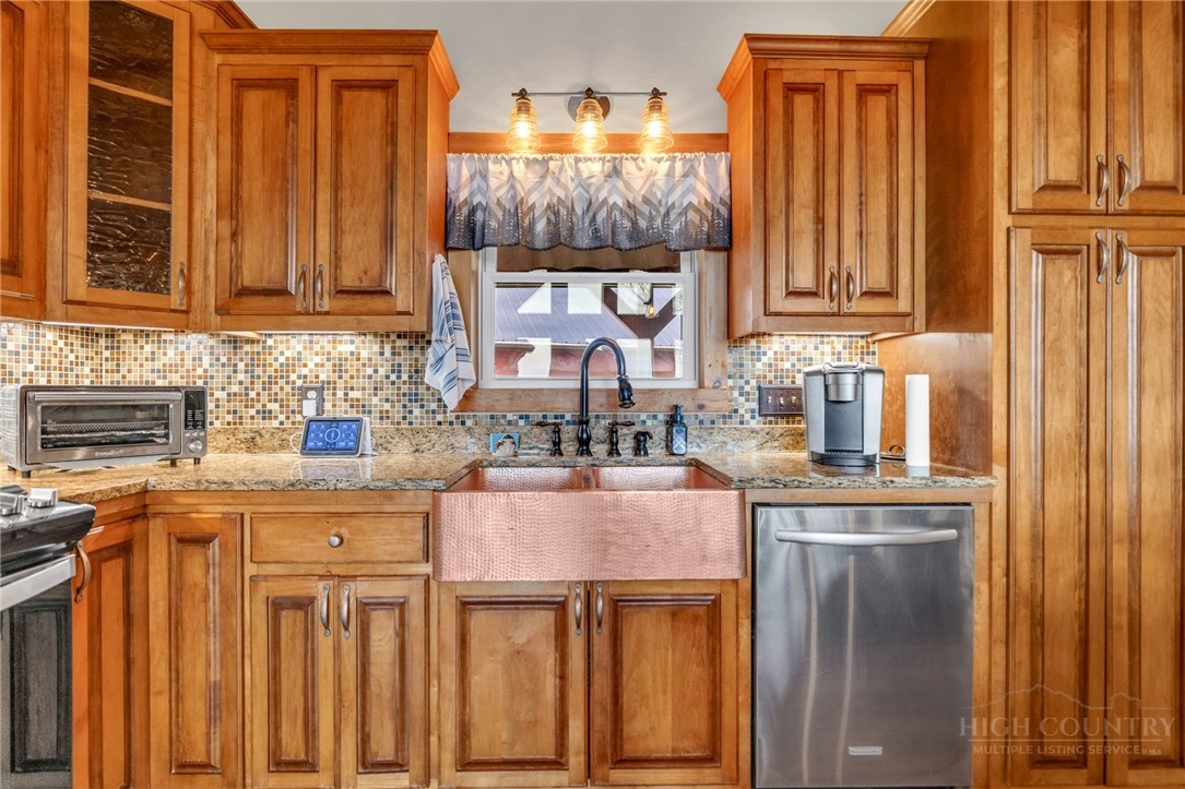 7994 3 Top Road Todd, NC 28684 - Photo 11 of 50 a kitchen with granite countertop a sink and a refrigerator