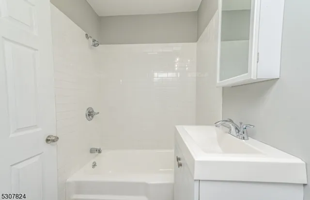 a white bath tub sitting next to a white sink