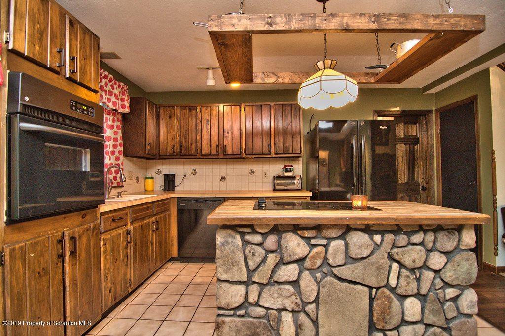 162 Highland Road Dalton, PA 18414 - Photo 11 of 44 a kitchen with stainless steel appliances a stove a sink and a refrigerator