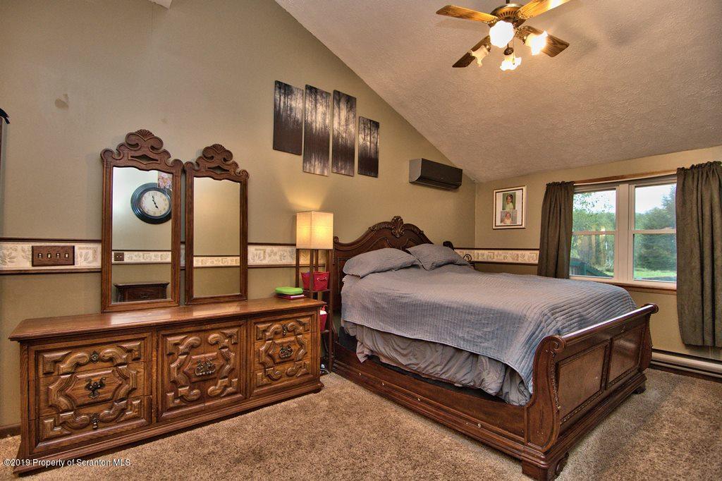 162 Highland Road Dalton, PA 18414 - Photo 15 of 44 a bed sitting in a bedroom next to a window