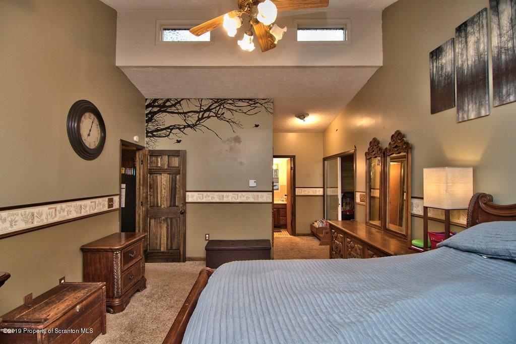 162 Highland Road Dalton, PA 18414 - Photo 16 of 44 a bedroom with a bed and a chandelier