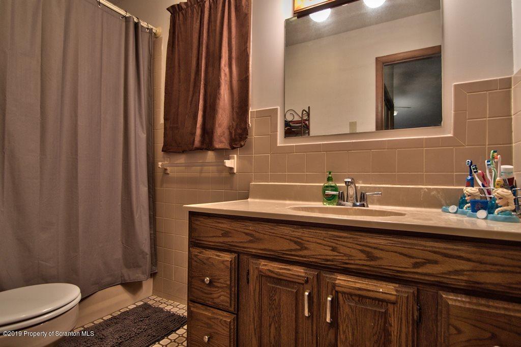 162 Highland Road Dalton, PA 18414 - Photo 17 of 44 a bathroom with a granite countertop sink and a mirror