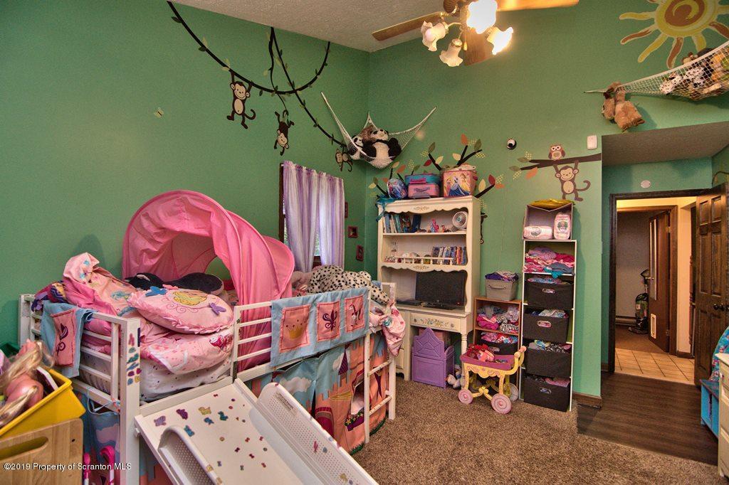 162 Highland Road Dalton, PA 18414 - Photo 22 of 44 a living room with lots of furniture and a chandelier
