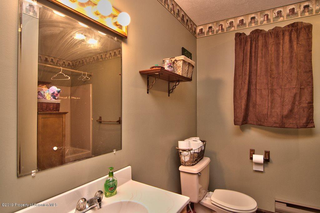 162 Highland Road Dalton, PA 18414 - Photo 24 of 44 a bathroom with a toilet a sink and shower
