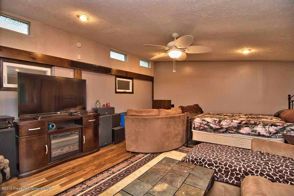 162 Highland Road Dalton, PA 18414 - Photo 25 of 44 a living room with a couch and a flat screen tv