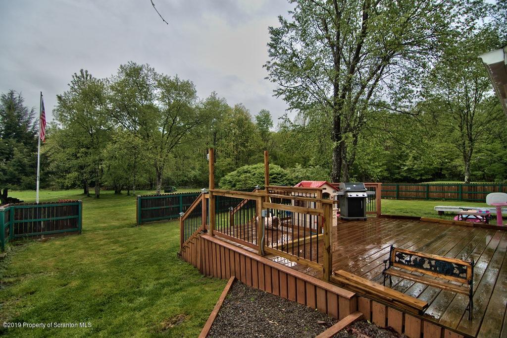 162 Highland Road Dalton, PA 18414 - Photo 33 of 44 a view of a house with backyard wooden deck and lake