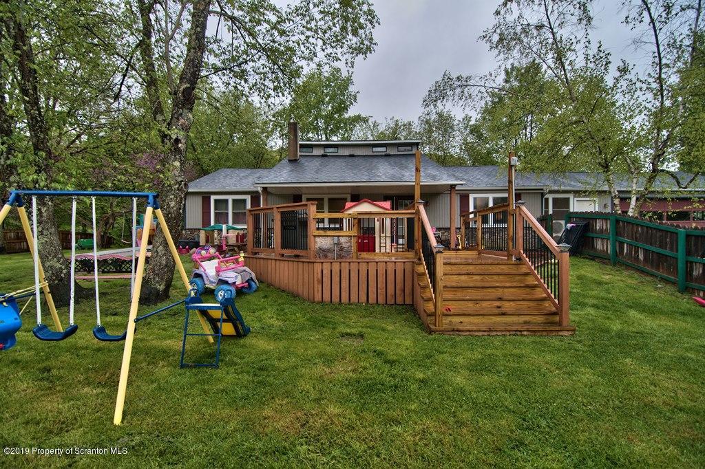 162 Highland Road Dalton, PA 18414 - Photo 34 of 44 a view of a house with a deck and a slide