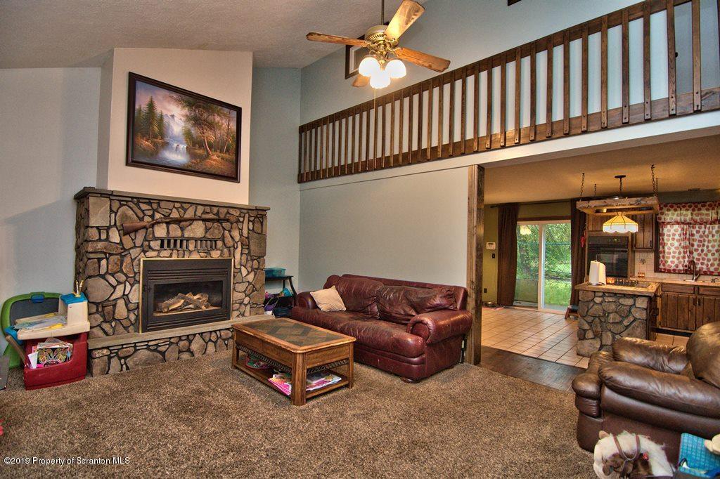 162 Highland Road Dalton, PA 18414 - Photo 7 of 44 a living room with furniture a window and a fireplace