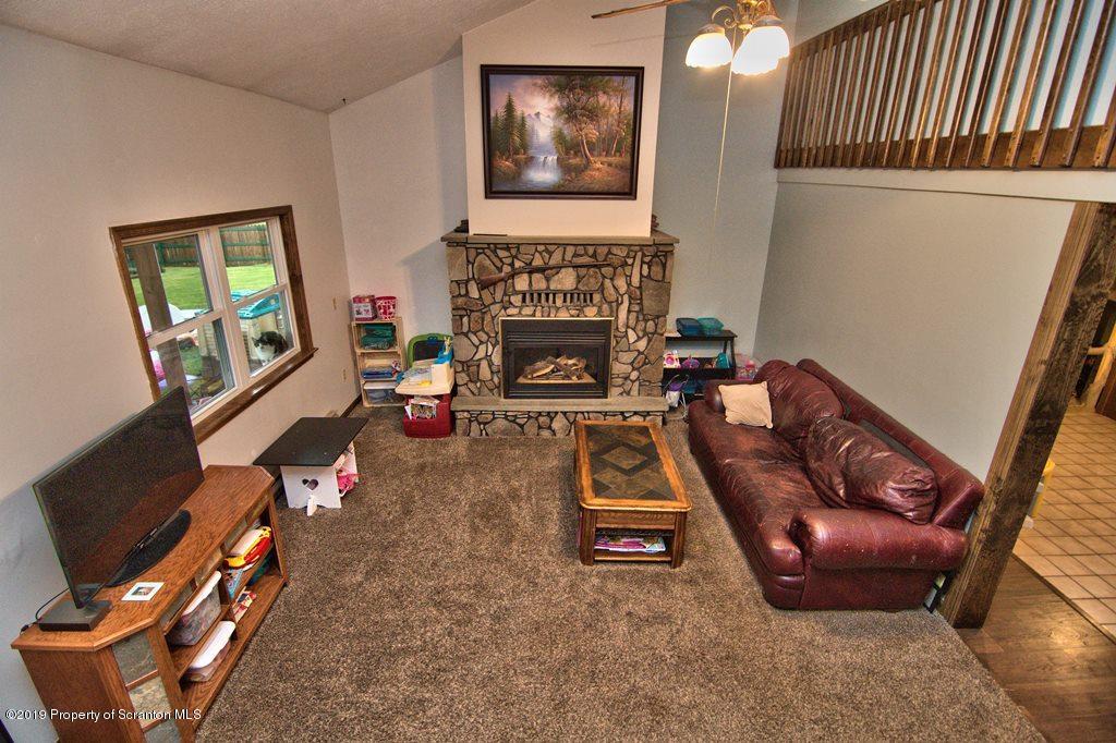 162 Highland Road Dalton, PA 18414 - Photo 8 of 44 a living room with furniture and a fireplace