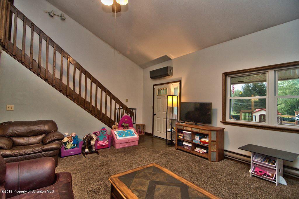 162 Highland Road Dalton, PA 18414 - Photo 10 of 44 a room with furniture and a flat screen tv