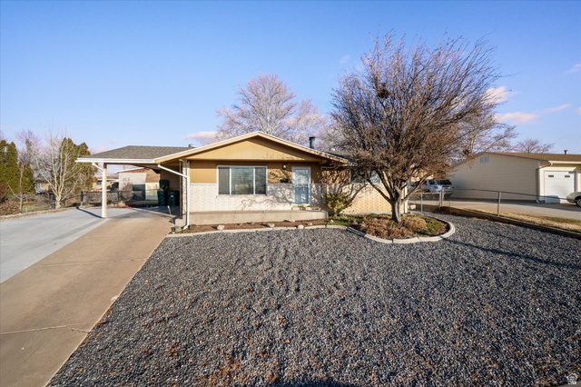 4248 South 2400th Street West Roy, UT 84067 - Photo 1 of 1 Ranch-style home featuring concrete driveway, a carport, brick siding, and stucco siding