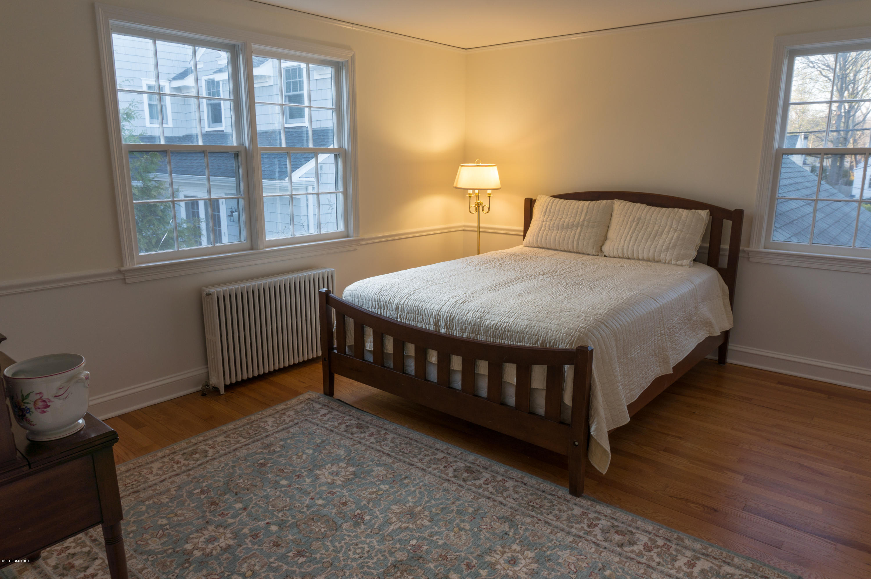 14 Spring Street Riverside, CT 06878 - Photo 12 of 15 a bedroom with a bed window and a wooden floor