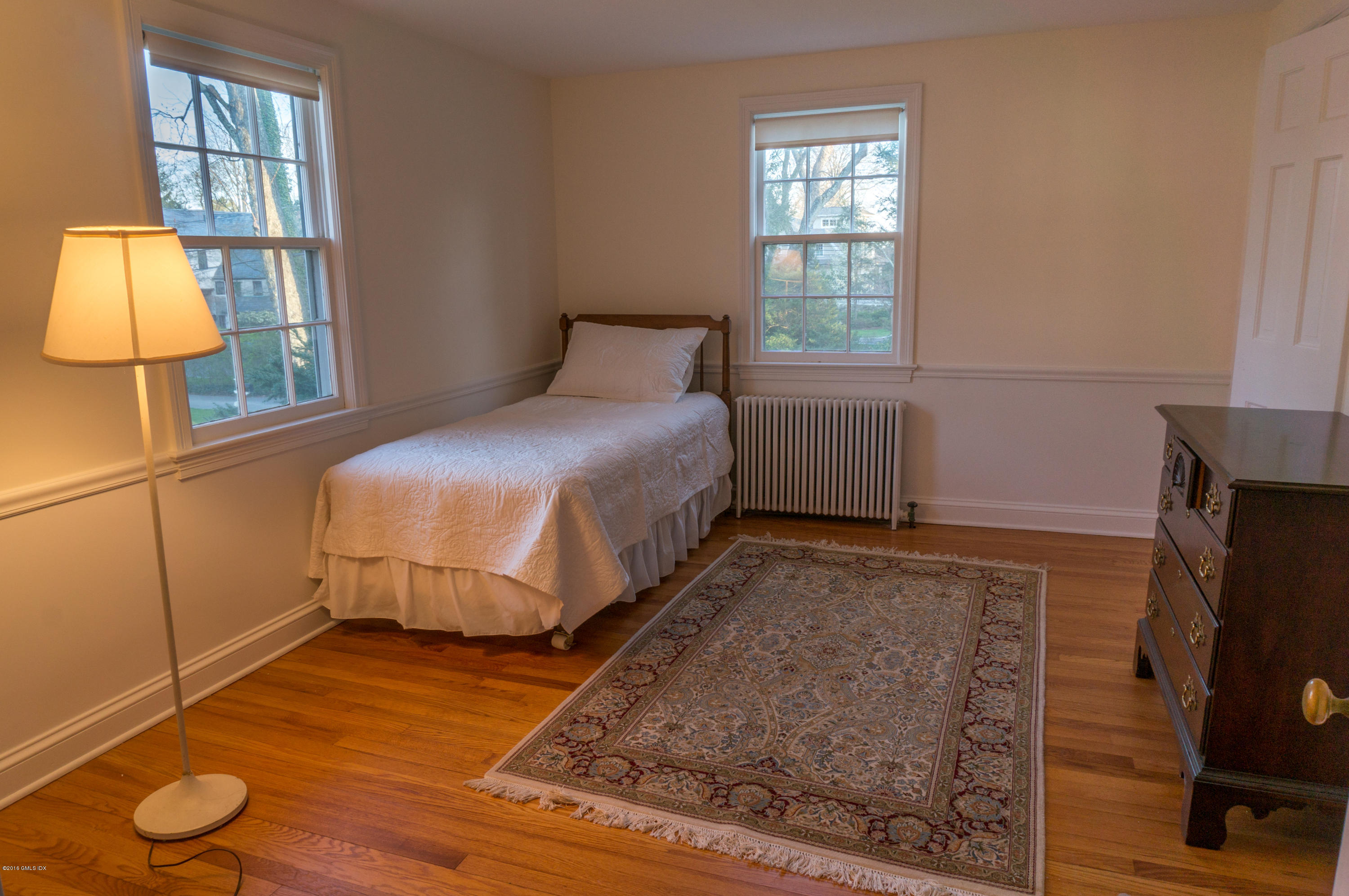 14 Spring Street Riverside, CT 06878 - Photo 15 of 15 a bedroom with a bed and large window