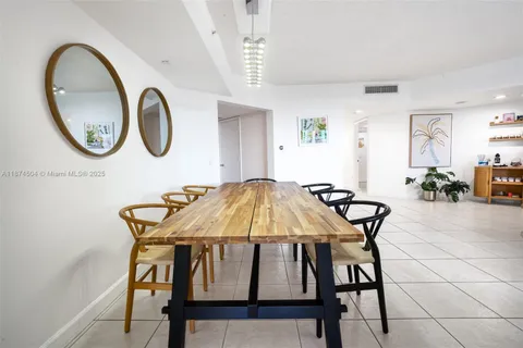 a dining room with furniture and a mirror