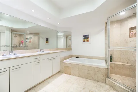 a spacious bathroom with a tub sink shower and mirror