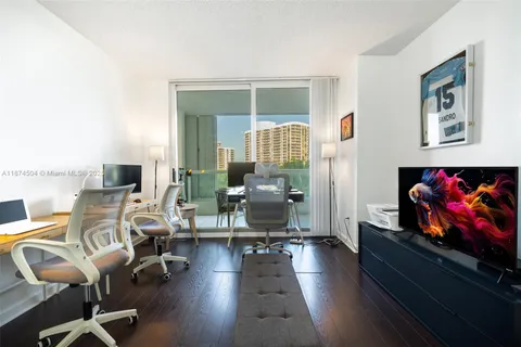 a living room with furniture gym equipment and a large window