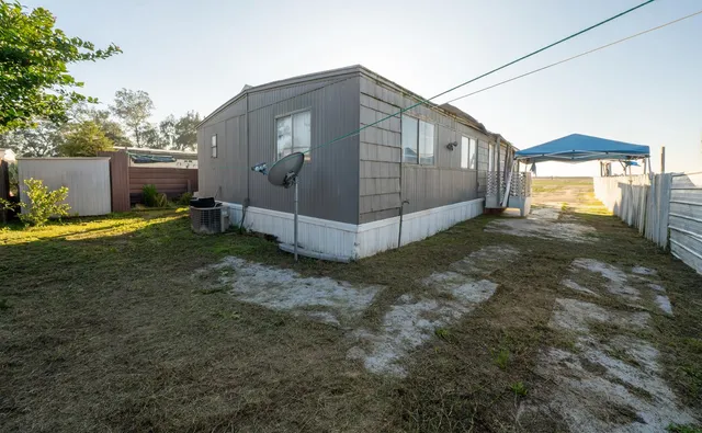 a view of a house with backyard and sitting area