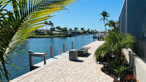a view of a lake with couches and wooden floor
